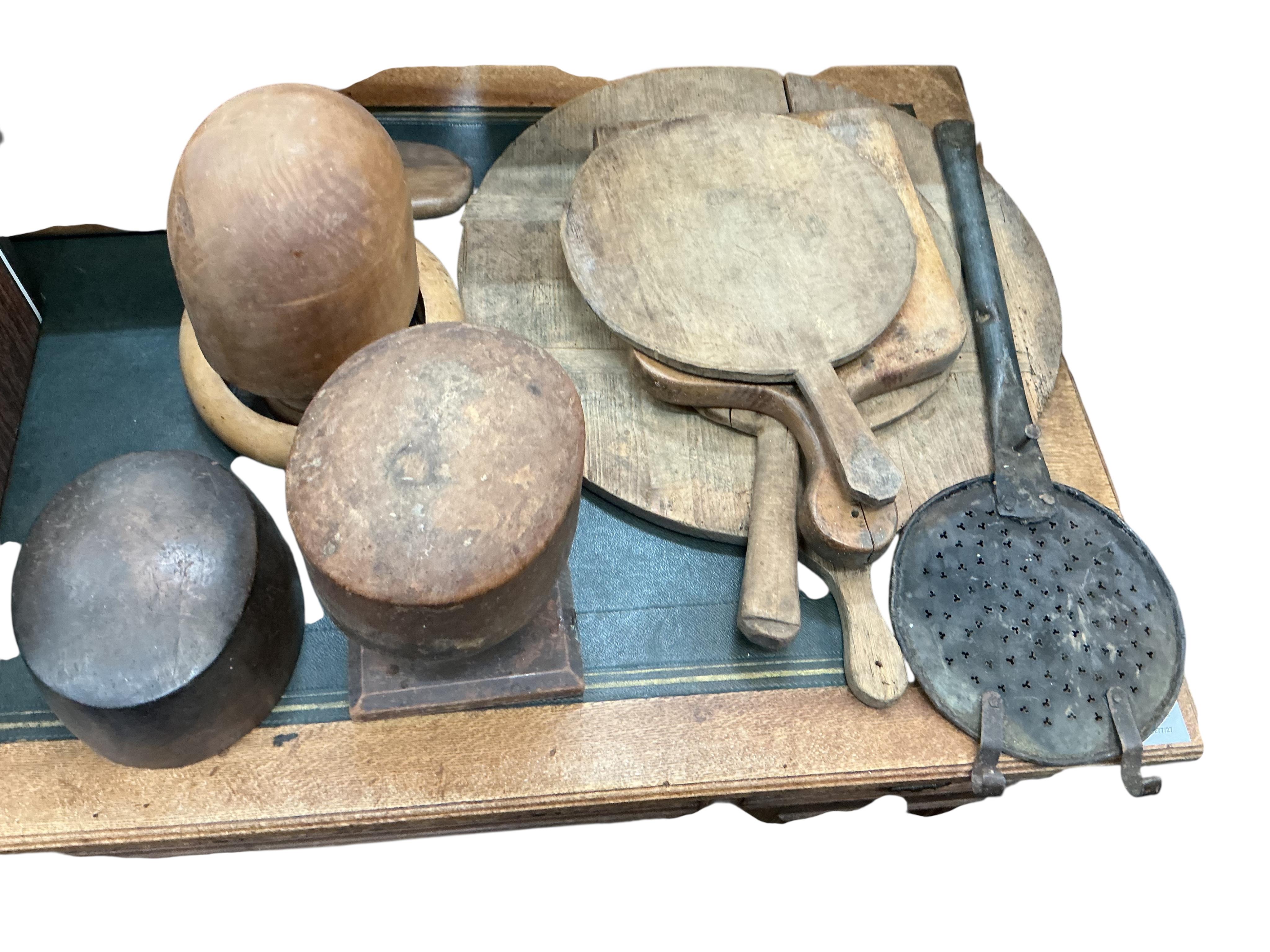 A quantity of assorted 19th century and later treen, chopping boards, hat moulds, etc.